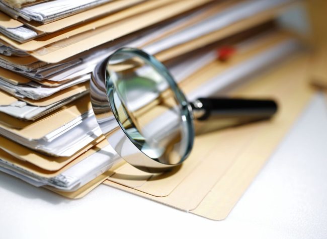 Documents Search Magnifying glass Search Documents ; shot with very shallow depth of field